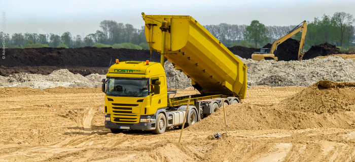 NOSTA truck unloads sand.